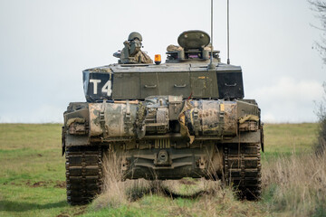 Fototapeta premium detailed close up of a commander and gunner directing action in a British army FV4034 Challenger 2 ii main battle tank on a military combat exercise, Wiltshire UK