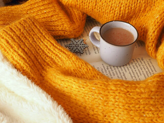 Cup of hot chocolate cacao and  warm knitted sweater for cold days
