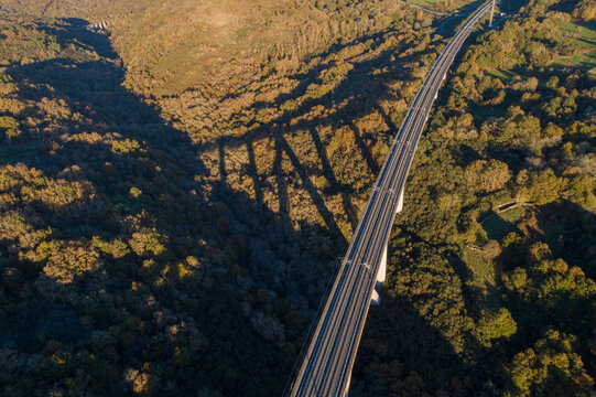 drone aerial view of a high speed railway line on a viaduct at sunset © Vic