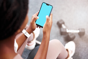 Fitness, smartphone in hands and mockup with green screen, black woman and app for exercise and weightlifting with dumbbell in gym. Sports marketing, wellness and phone with virtual workout class.