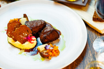 Deer tenderloin. Truffle-potato puree, porcini mushrooms, baked leek and carrot, juniper bread, port wine sauce. Delicious healthy traditional food served for lunch in modern gourmet restaurant