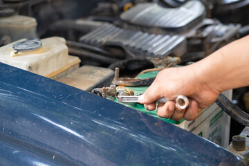 Hands of car mechanic in auto repair service