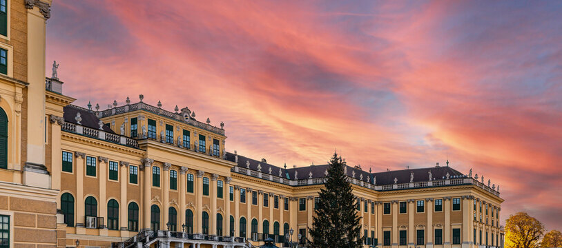 VIENNA, AUSTRIA - NOVEMBER 25, 2022: Sch&ouml;nbrunn Palace and its Christmas tree at sunset..Traditional panorama of the Christmas market at Sissi Castle in Vienna.