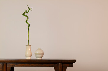 Bamboo, Chinese antique ceramics on wooden table against white wall