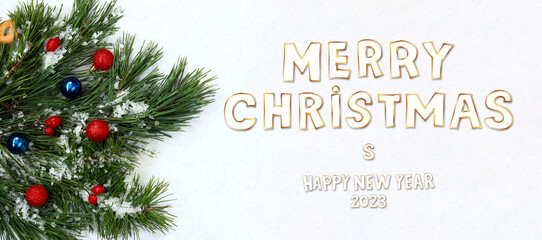 Fototapeta na wymiar Merry Christmas and Happy New Year 2023, christmas banner or card. Composition of pine branches with long needles and Christmas balls, artificial snow
