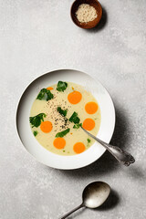 photography of a bowl of soup with a spoon in it - AI Generated
