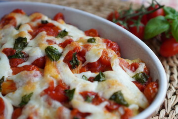 Italian baked pasta PACCHERI con tomatoes, mozzarella and fresh basil