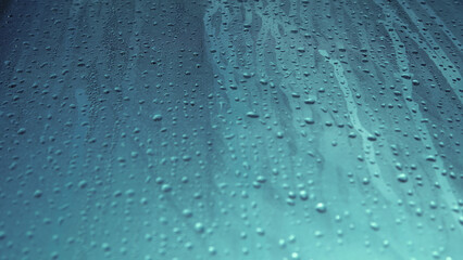 Condensation on window glass in frosty winter weather. Background in the form of small drops on the glass.