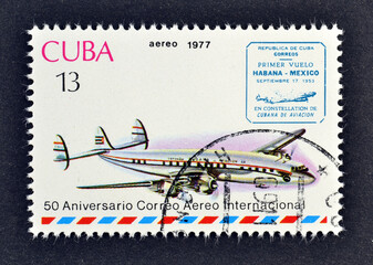 Cancelled postage stamp printed by Cuba, that shows Airplane, Lockheed L.1049 Super Constellation and Havana-Mexico cache, circa 1977.