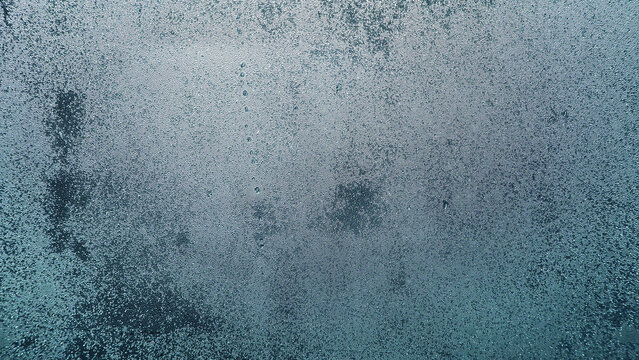 Condensation on window glass in frosty winter weather. Background in the form of small drops on the glass.