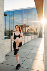 Young sportswoman doing workout outdoors