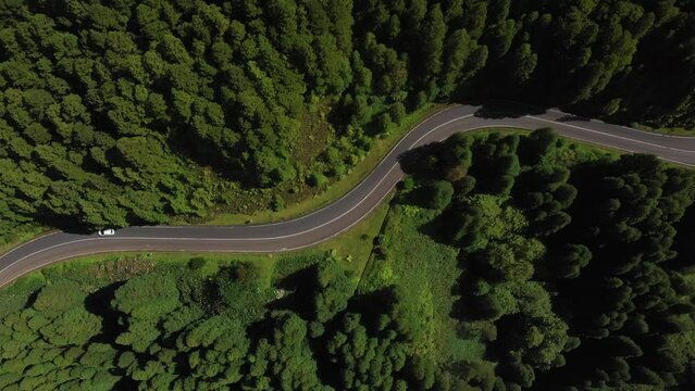Epic drone footage of cars on mountain roads. Top view with slow motion. Azores. Sao Miguel island, Portugal. Aerial view of remarkable volcanic landscapes. 4K.