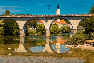 Beautiful summer view with reflections, an ancient bridge and a church at Vilshofen, Danube, Bavaria, Germany