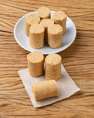 Pacoca, typical brazilian peanut candy and june festival food over wooden table