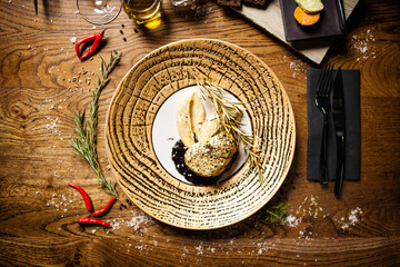 Black Angus tenderloin steak covered with 24 carat gold, potato puree, red wine sauce with berries, rosmarine on a plate. Delicious healthy food served for lunch in modern gourmet cuisine restaurant