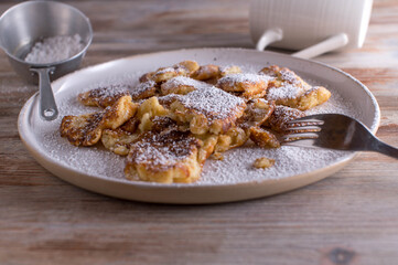 Kaiserschmarrn fresh and homemade baked on a white plate