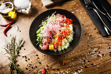 Poke with beef: Glass noodle, avocado, edamame and mango in a bowl. Delicious healthy food closeup served for lunch on a table in modern gourmet cuisine restaurant