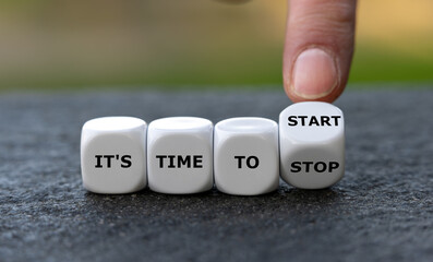 Hand turn dice and changes the expression 'it's time to stop' to 'it's time to start'.