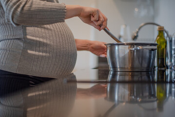 pregnant woman preparing postpartum meals