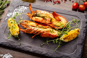 Lobster with flavored butter. Herb butter, lemon. Delicious healthy traditional food closeup served for lunch in modern gourmet cuisine restaurant
