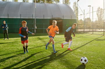 Young boys in sports soccer club on training unit improving skills