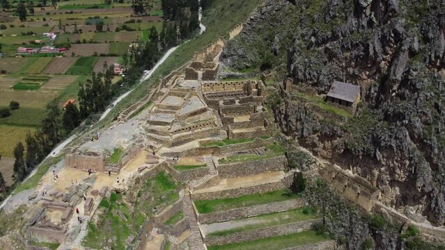 Birdseye view flying away from ancient ruins and village in Peru.