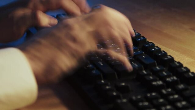 A man typing on computer keyboard