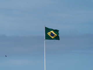 Brazil national flag textile cloth waving on top, blue sky brazil, patriotism concept.