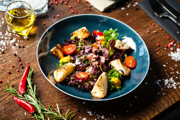 Warm chicken liver salad with port wine-honey sauce. Carrot cream, bacon, cherry tomatoes, brioche. Delicious healthy traditional food closeup served for lunch in modern gourmet cuisine restaurant