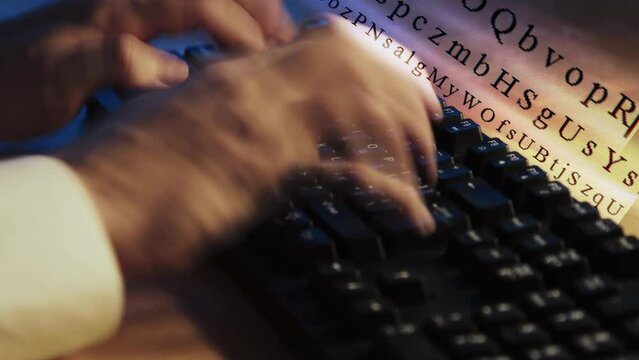 A man typing on computer keyboard