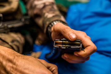 a handful of bullets in the hands of a soldier. bullet shop