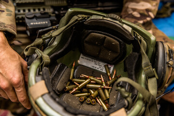 a handful of bullets in the hands of a soldier. bullet shop