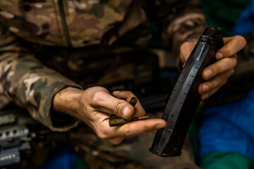 a handful of bullets in the hands of a soldier. bullet shop
