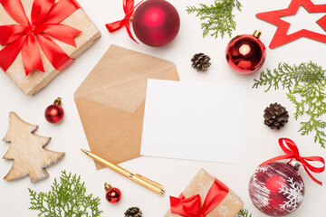 Craft envelope with christmas decoration on concrete background, top view