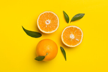 Flat lay with fresh oranges and leaves on color background