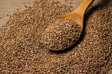 Buckwheat on a background of burlap. Tasty and healthy food