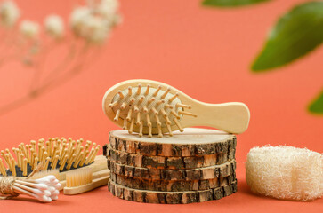 Wooden comb on a natural wooden podium. Photo for advertising a comb or a hairdresser