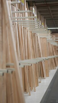 Vertical shot of planks of timber in carpentry store warehouse