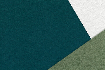 Texture of craft dark emerald color paper background with green and white border. Vintage abstract olive cardboard.