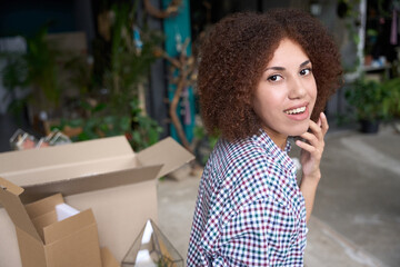 Cheerful young woman working in gift shop