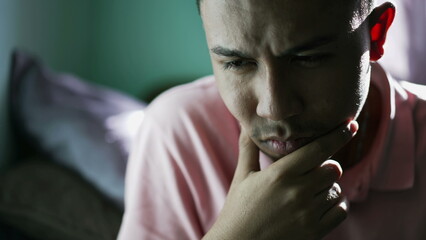 Thoughtful person thinking deeply about solution. Pensive South American latin hispanic young man...