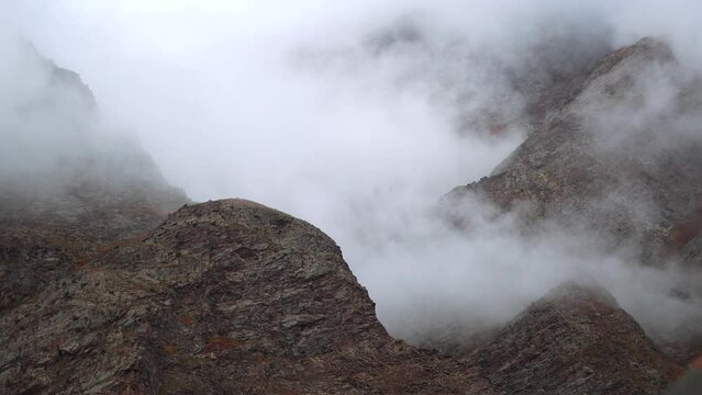 4K shot of clouds above the mountain peaks during the storm at Jispa in Lahaul Spiti district at Himachal Pradesh in India. Clouds covers the peaks of the mountains. Natural background.	