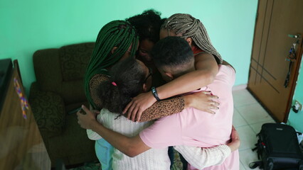 Happy hispanic family hugging each other at home. South American people embraces