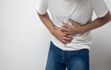 man having abdominal pain on white background
