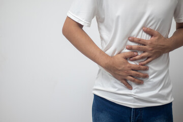 man having abdominal pain on white background