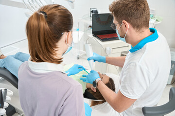 Dentist scanning patient mouth with digital intraoral scanner