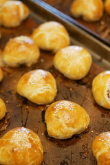 Freshly baked bread lies on the shelves ready for sale. 