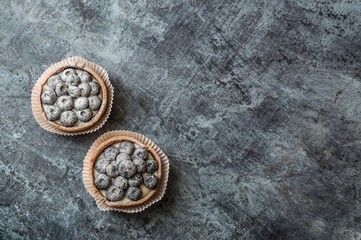 Blueberry goat cakes with blue berries on dark vintage background