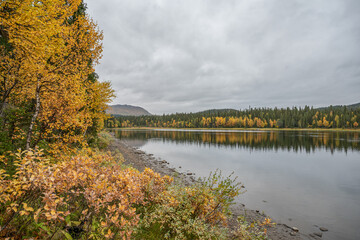 camping caravan near river autumn fall landscape along Ammarnas National Park in Lapland Sweden