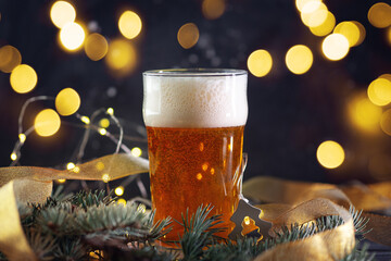 glass of light beer on a Christmas bokeh garlands background
